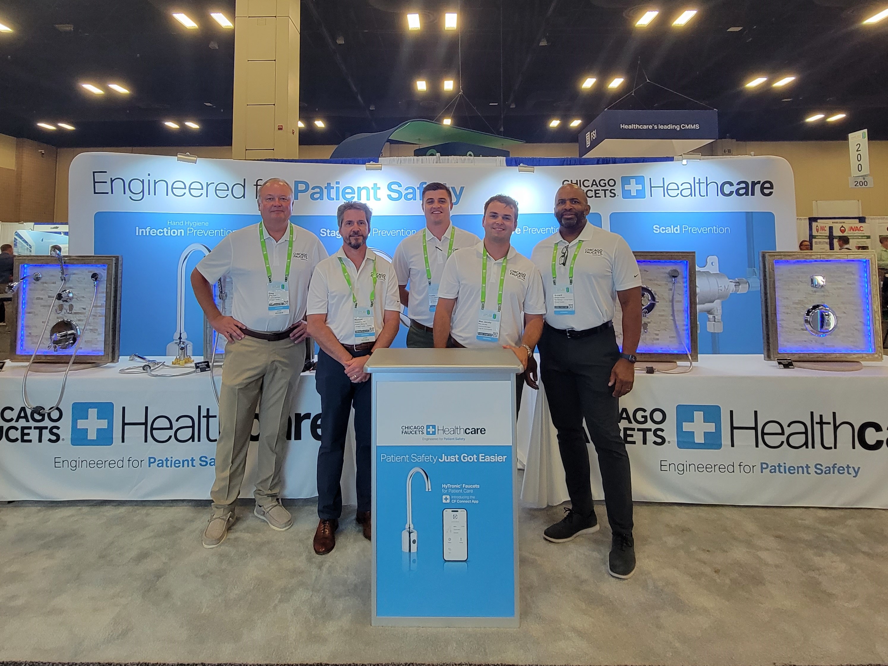 five booth staff standing in booth 