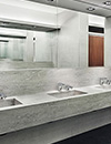 Public restroom with E-Tronic® 80 touchless faucets and soap dispensers