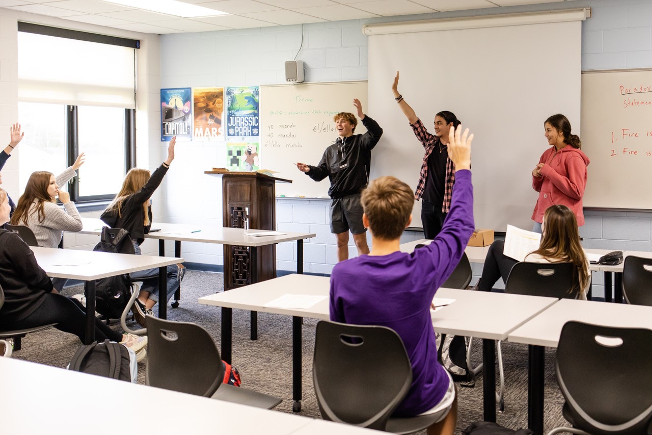 Northpointe classroom with students raising their hands
