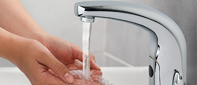 HyTronic® TempShield® faucet with flowing water and hands